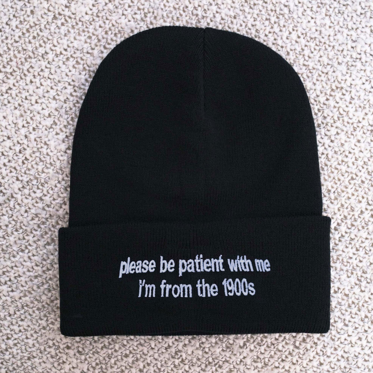 May include: Black beanie with white embroidered text that reads "please be patient with me I'm from the 1900s"