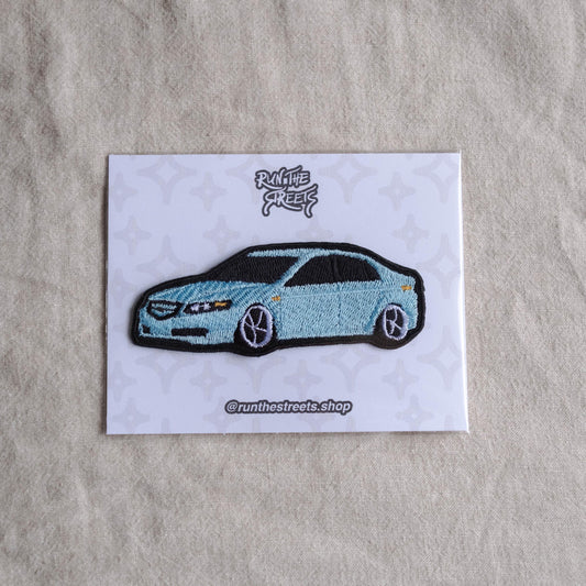 May include: A light blue car patch with black accents, featuring the text "Run the Streets" and "@runthestreets.shop" on a white card with a star pattern. The car has black wheels and a black roof.